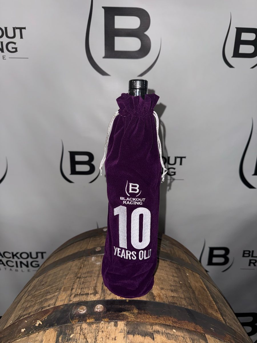 A purple bag marked 10 years old on a barrel