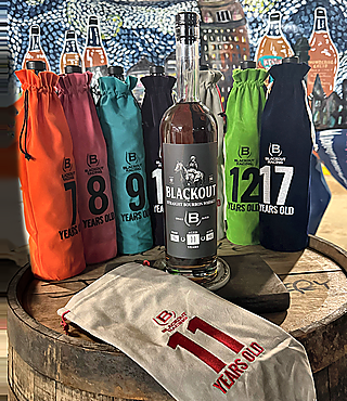 A Blackout bottle in front of numbered bags