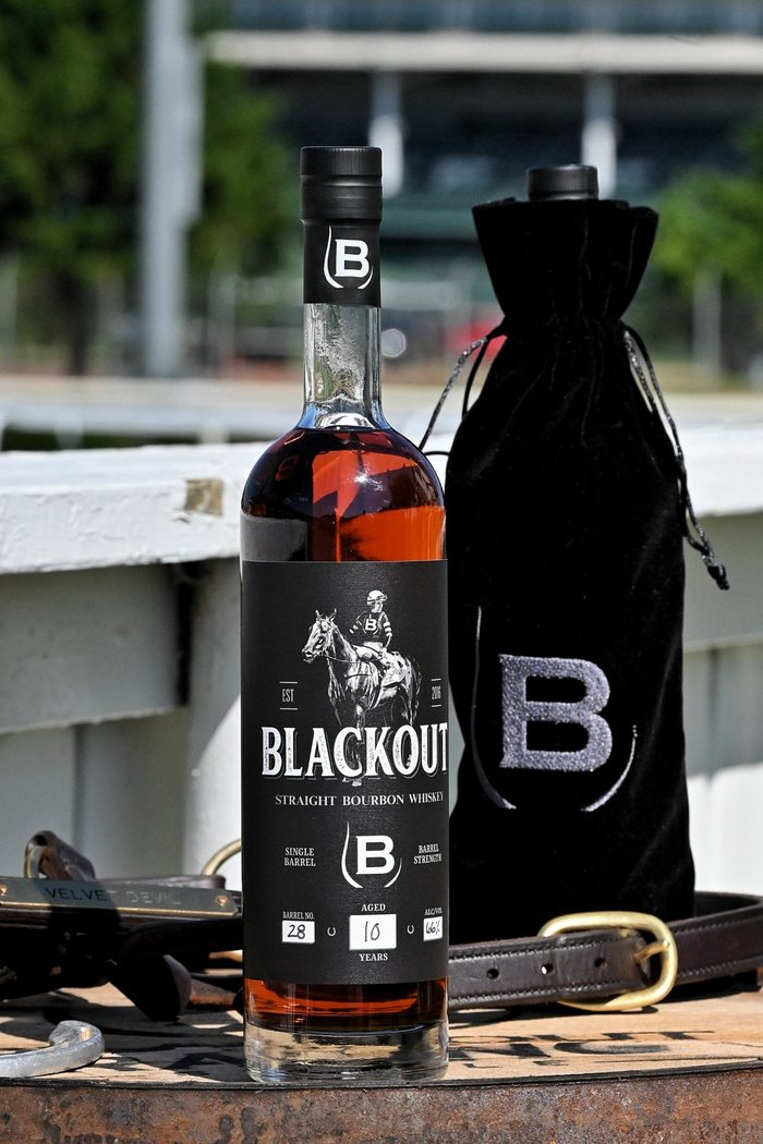A Blackout bottle and a black bag outdoors